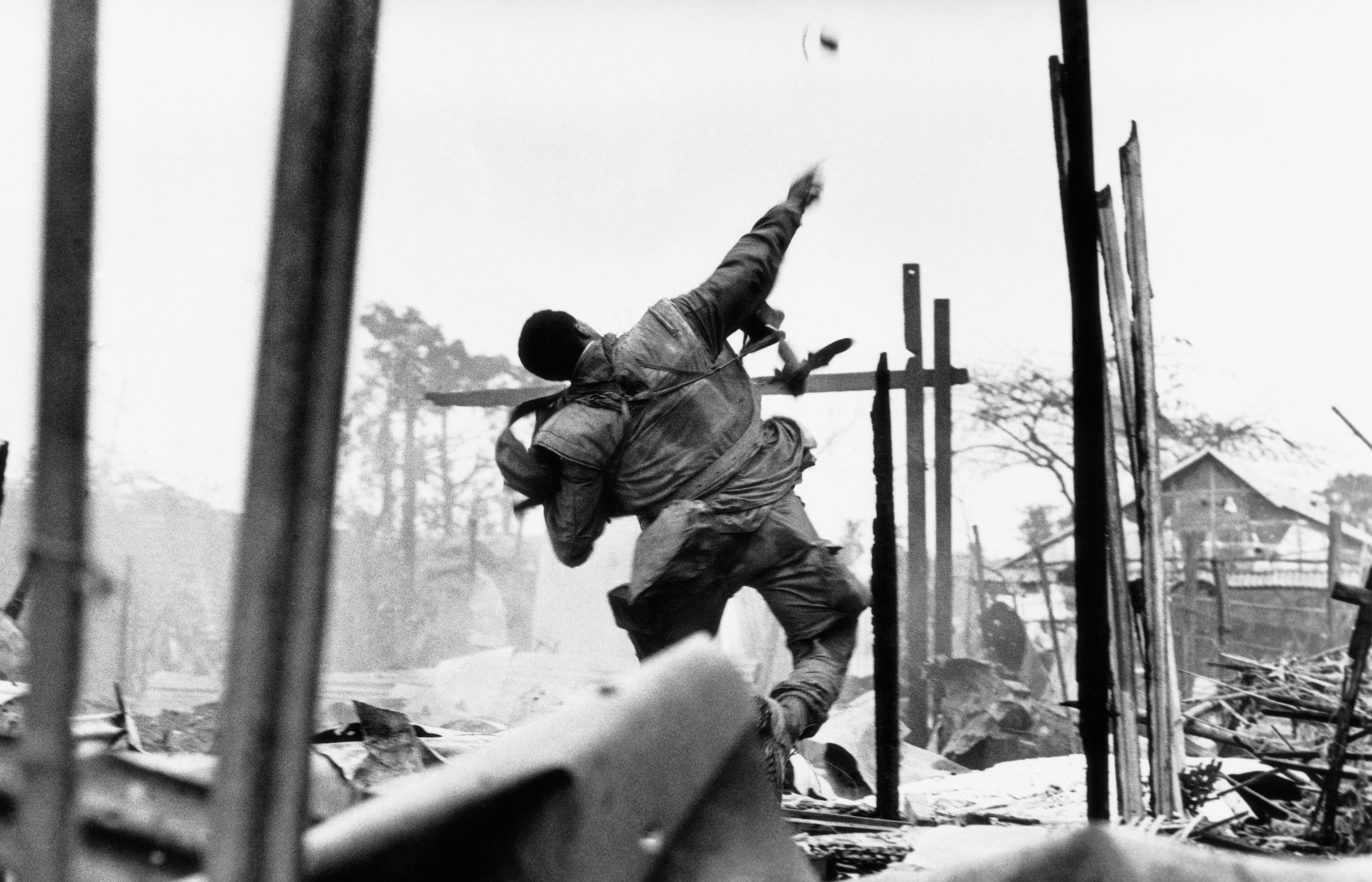 A U.S. Marine throwing a grenade during the Tet Offensive in Hue, Vietnam.