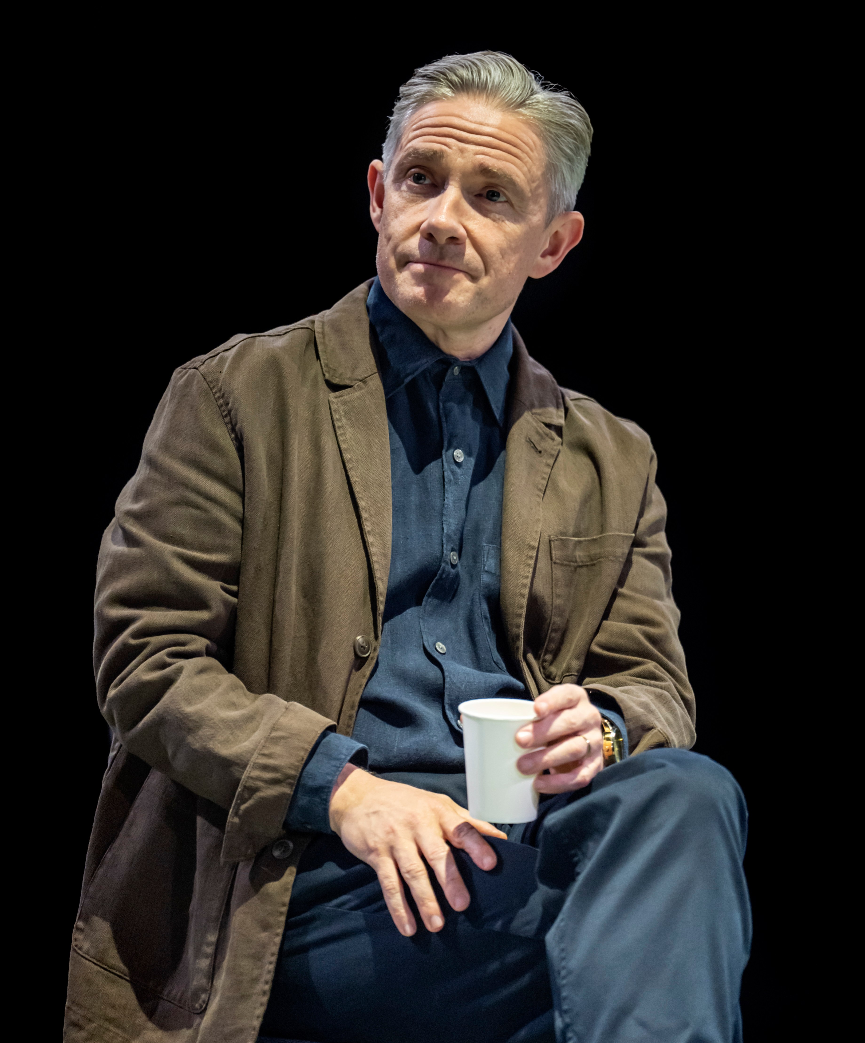 Martin Freeman holding a disposable cup.