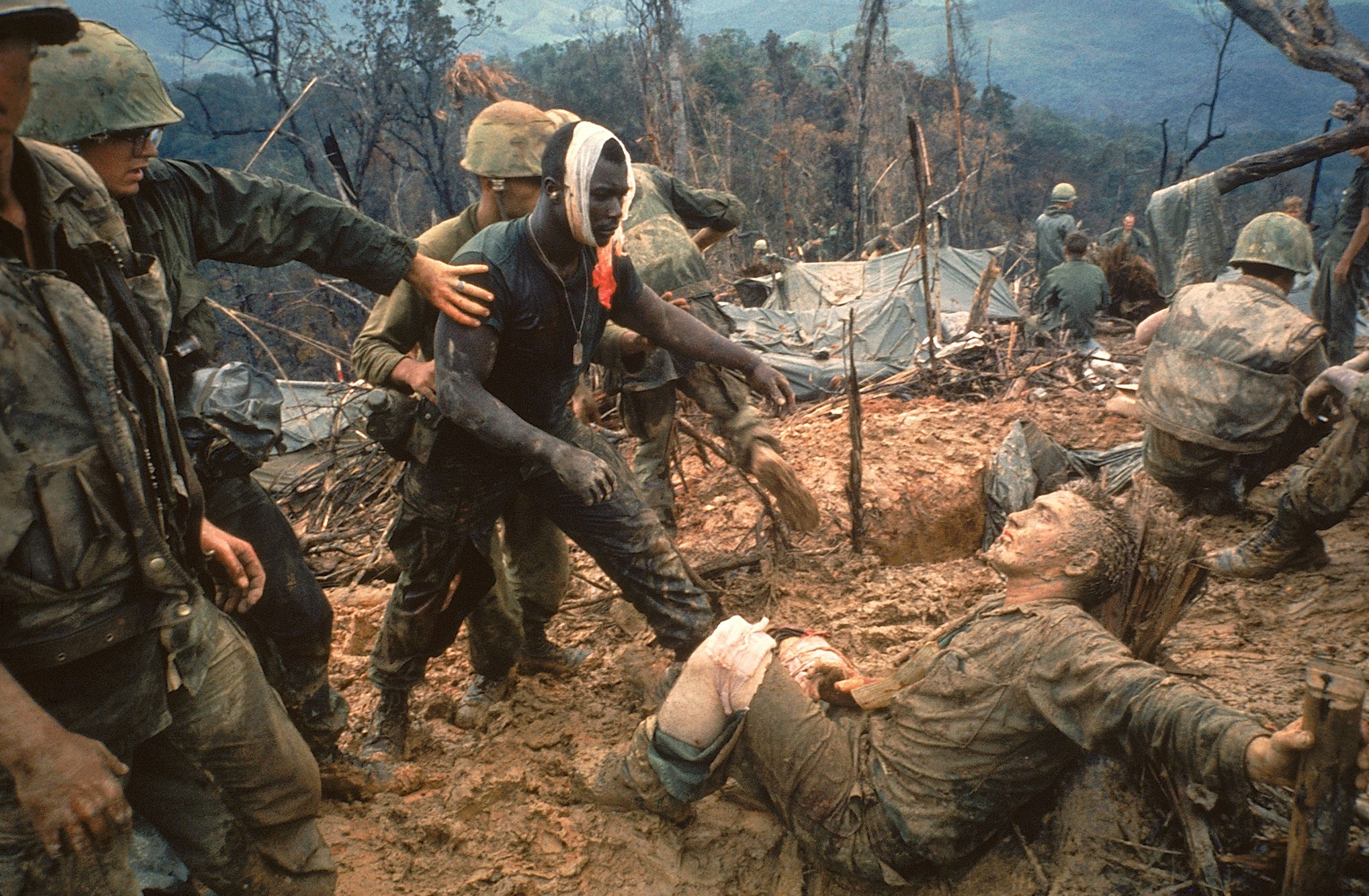Wounded Marines are helped after a firefight in Vietnam.