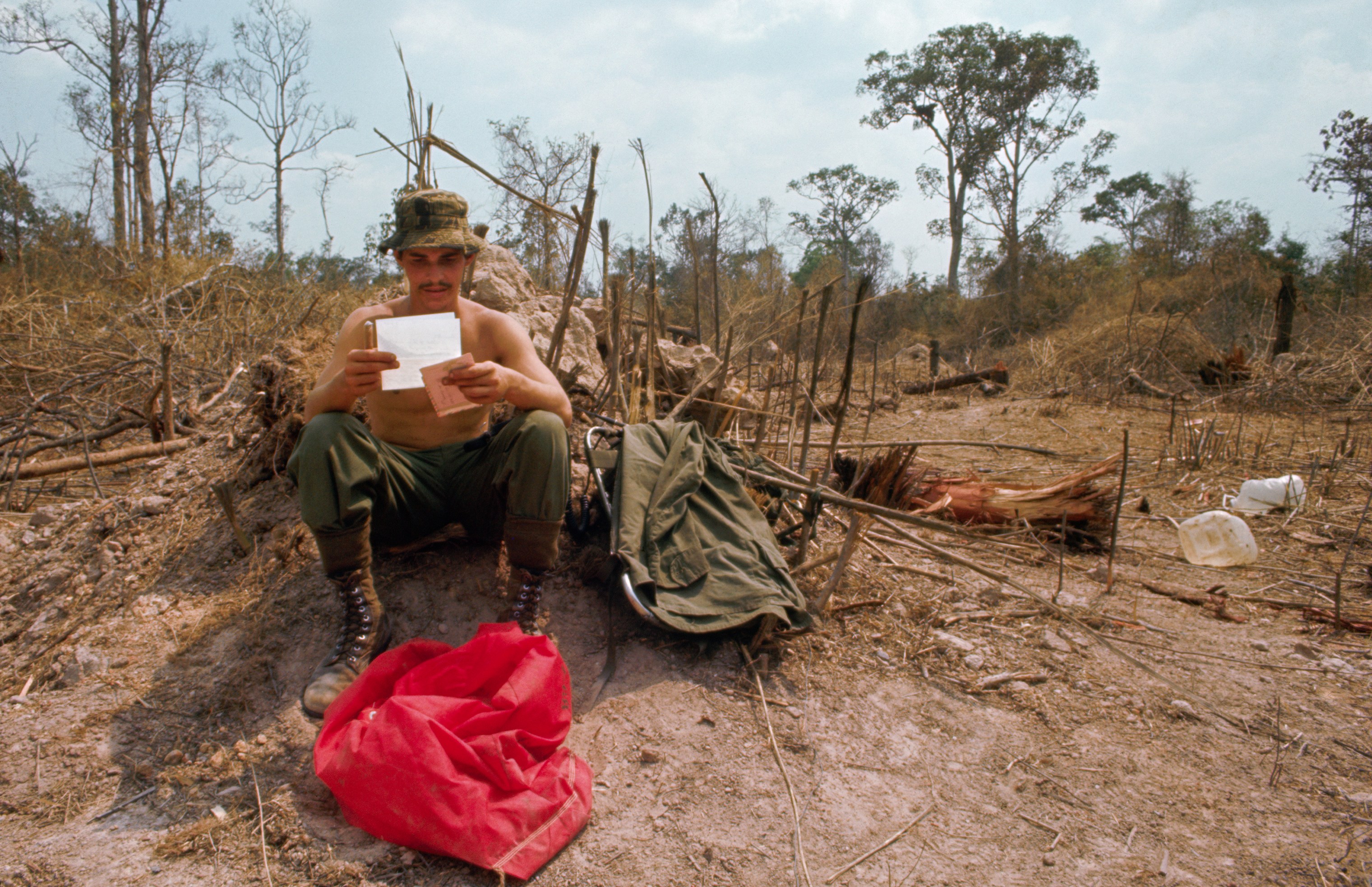 A US paratrooper reading a letter during the Vietnam War.