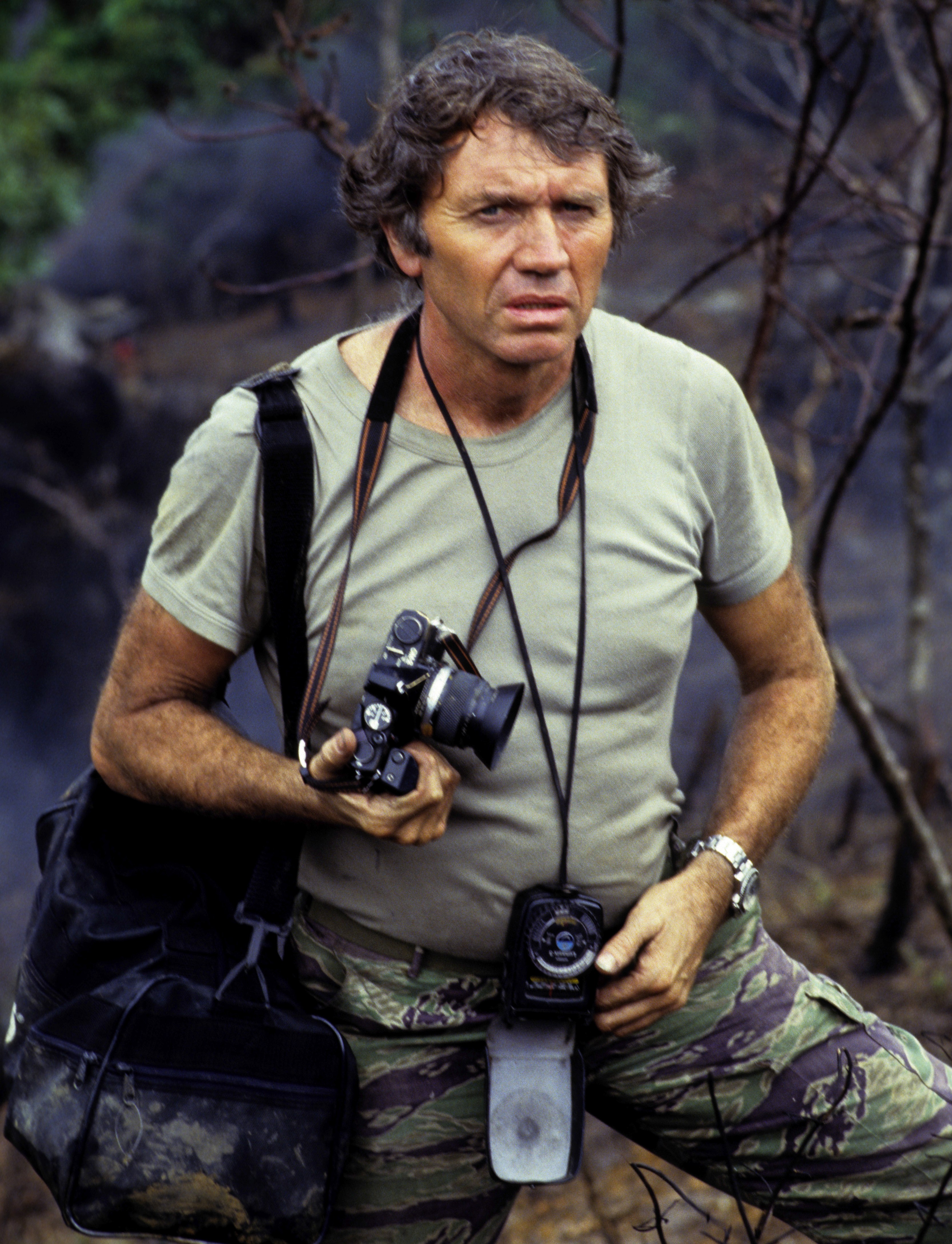 Don McCullin, esteemed war photographer, with his camera in the Philippines.